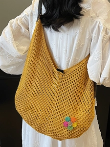 Fashionable ginger yellow crochet tote bag with colorful flower for summer beach vacations