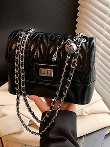 Fashionable black pleated leather crossbody bag with silver chain strap and metal lock
