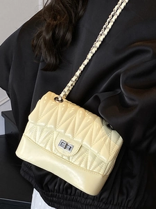 Chic beige quilted leather crossbody bag with chain strap and metallic lock for summer 2025