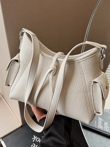 Minimalist beige crossbody bag with textured faux leather and knotted strap design