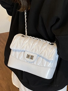 Chic V-quilted faux leather crossbody bag with silver chain strap and twist lock