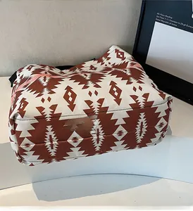 Detailed view of large canvas tote bag featuring brown geometric diamond print patterns