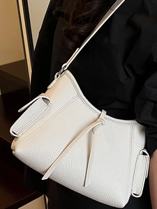 Minimalist beige lychee grain leather shoulder bag with side pocket and sleek strap