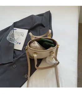 Top view of beige bucket bag showing spacious interior with phone, umbrella and accessories