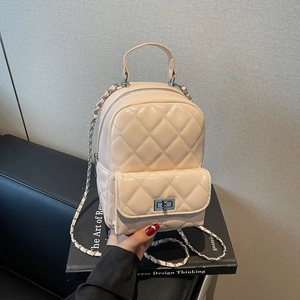 Close-up of beige quilted mini backpack with silver twist lock and chain strap
