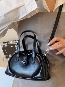 Glossy black heart-shaped buckle dumpling handbag with adjustable crossbody strap