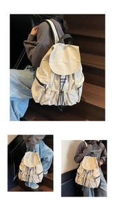 Detail of cream nylon backpack featuring drawstring closure and functional side zipper pocket