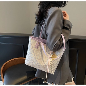Detailed back view of a large lilac floral tote bag worn over a grey blazer