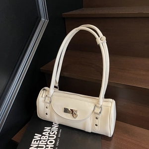 Détail du sac Boston en cuir verni blanc cassé avec pendentif cœur et boucles argentées