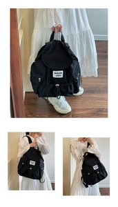 Detail of the drawcord closure and flap on this large black nylon travel backpack