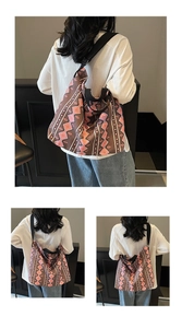Detail of large ethnic canvas tote bag featuring geometric patterns and black shoulder strap