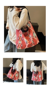 Detail of red canvas tote bag featuring ethnic geometric patterns and sturdy black straps