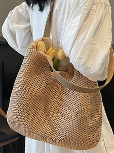 Handmade hollow straw woven tote bag with canvas straps and large capacity for beach travel