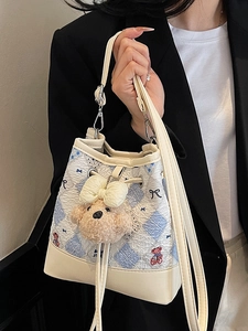 Chic quilted bucket bag with cute bear pattern and charm for modern women's fashion