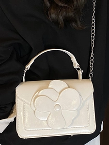 Elegant white glossy square bag with 3D floral petals and silver chain strap