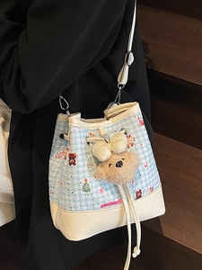 Blue plaid bucket bag with cartoon bear pattern and plush keychain accessory
