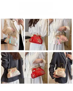 Detail of Chinese shell bag with silk embroidery, metal handle and pearl chain strap