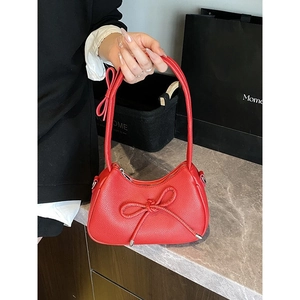 Chic red bow dumpling bag with lychee texture and slim handle for summer fashion