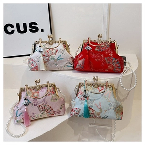 Detail showing four embroidered cheongsam-style evening bags with pearl chains and tassels