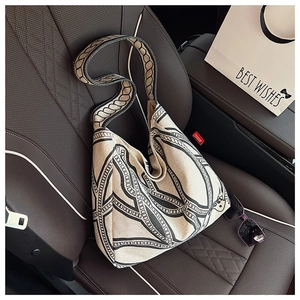 Detail of printed canvas tote bag featuring chain patterns on a car seat setting