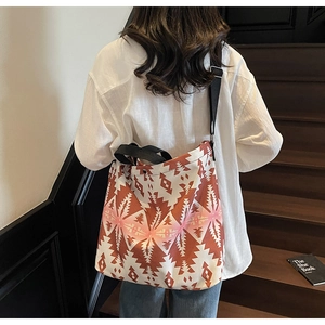 Detail of large canvas tote bag with geometric print and adjustable black shoulder strap