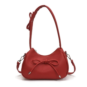 Solid red lychee leather crescent bag with bow accents for casual summer fashion
