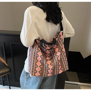 Detail of bohemian geometric pattern canvas tote bag with thick black straps