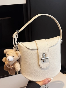Minimalist creamy beige lychee grain underarm bag with a cute bear charm and silver lock
