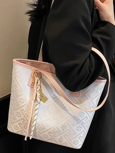 Chic geometric pattern tote bag with pink trim and luxury gold pendant detail