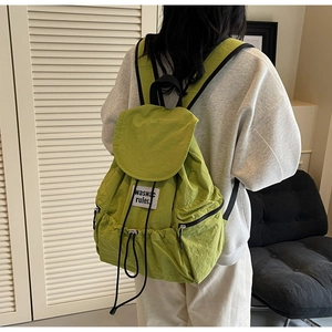 Detailed back view of casual avocado green nylon drawstring backpack with side zipper