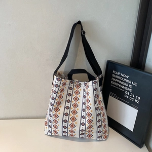 Detail of bohemian canvas tote bag showing printed geometric patterns and black straps