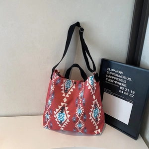Detail of red canvas tote bag with ethnic geometric pattern and adjustable strap