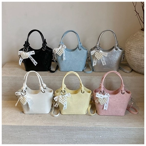 Chic bucket bags in six colors with knotted handles and pearl heart lace charms