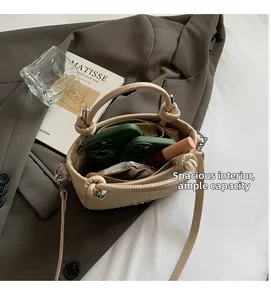 Internal view of beige bucket bag showing capacity for two phones and lipstick