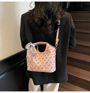 Detail of pink tote bag with bear print and black and white checkered ribbon bow