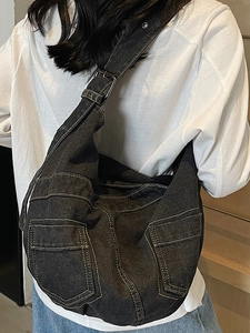 Large black denim crossbody bag with contrast stitching and multi-pocket cargo style