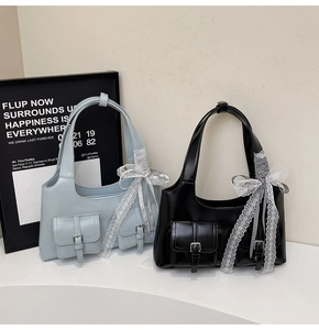 Dettaglio delle borse in pelle PU con fiocchi in pizzo e tasche con fibbie metalliche