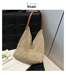 Detail of khaki crochet woven tote with brown leather strap on a decorative sofa