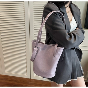 Detail of lavender crocodile embossed faux leather shoulder bag with MER PAI logo
