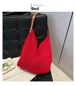 Detail of red woven hollow shoulder bag with brown leather strap for summer beach vacation