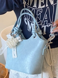 Light blue bucket bag with pleated texture, pearl lace charm and stylish top handles