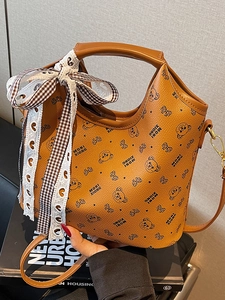 Classic orange leather tote bag with bear print and stylish black checkered ribbon bow