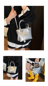 Silver metallic tote bag with lace bow and pearl heart charm shown in three wearing styles