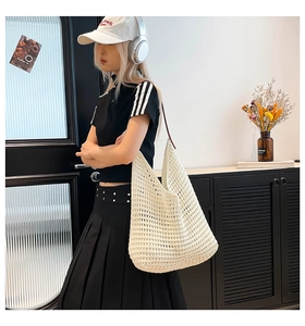 Detailed close-up of white hand-woven cotton hollow tote bag with premium leather straps