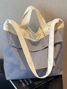 Blue and white striped canvas tote bag with cotton straps for summer commuting