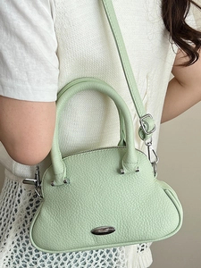 Chic mint green shell bag in lychee pattern leather with stylish silver hardware details