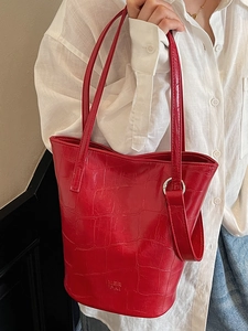 Chic red crocodile pattern bucket bag with elegant handles for stylish women