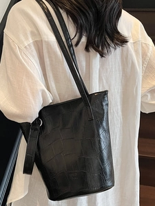 Chic black crocodile embossed bucket bag with long shoulder straps for daily commute