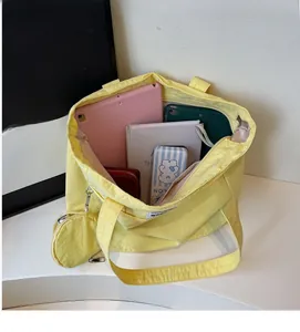 Interior view of yellow canvas tote bag showing large capacity for tablet and stationery