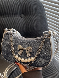 Blue denim half-moon underarm bag with silver bow, pearl chain and metal strap